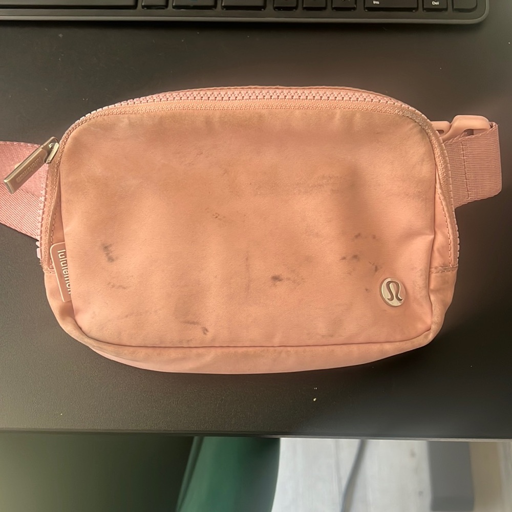 Well worn Lululemon belt bag in Pink Pastel.
